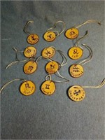 Twelve 2"wooden zodiac disc ornaments.