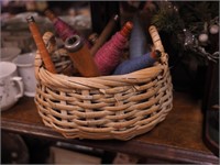 Basket with vintage wooden spools and yarn