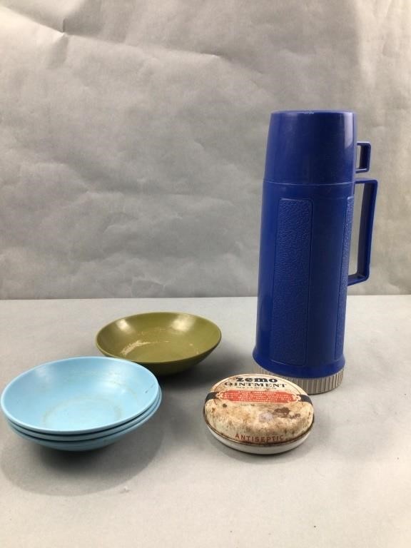 Blue thermos, plastic bowls, and ointment