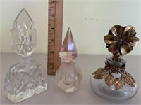 Three glass perfumes with stoppers