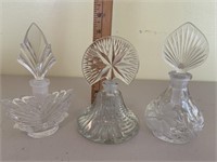 Three glass perfume bottles were stoppers