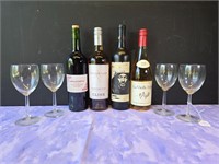 set of 4 wine glasses and 4 bottles of wine
