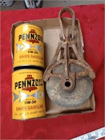 empty pennzoil cans and pulley