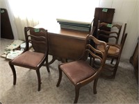 56" long drop leaf table, 3-14" leafs, 4 chairs,