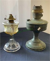 Antique oil lanterns - one glass and one metal -