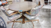 ROUND TABLE WITH 4 CHAIRS ON ROLLERS