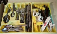 Trays of flatware and kitchen items