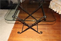 Glass top coffee table on an iron base 30" X 26"