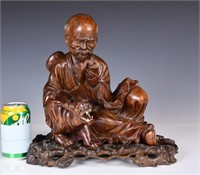 A Wood Carved Luohan Figure with Stand