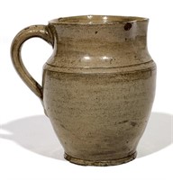 Redware cream pitcher, tan glaze, 4" dia., 5" tall
