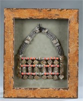 Framed Omani silver and coral necklace.