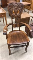 ANTIQUE OAK FACE CARVED BACK ARM CHAIR