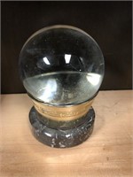 Glass ball with bass and gray stone holder