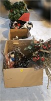 Row of boxes of xmas decor, garland, red rope