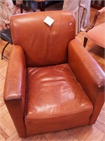 Brown leather upholstered armchair made by Coach