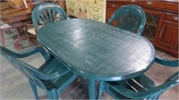 GREEN PLASTIC PATIO TABLE W/4 CHAIRS