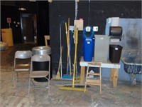 assorted brooms, trash cans