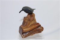 A Manatee Figurine on Burl Wood