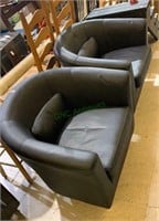 2 matching black vinyl barrel back arm chairs, in