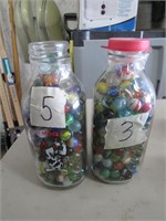 2 milk bottles of marbles