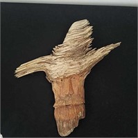 Driftwood face carving and slanted Rock Beer tap