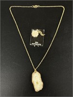 2 Alaskan ivory pendants 1 has a gold nugget set i