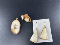 Scrimshawed walrus ivory pendant with 2 pairs of i