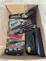 Assortment of folding knives, multi tools, and