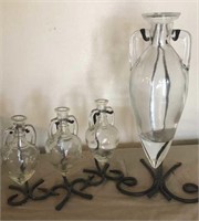 Suspended vases on wrought iron bases