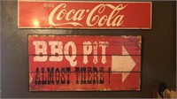 Vintage metal Coca-Cola sign and newer BBQ pit