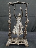 Bronze sculpture of a girl on a swing