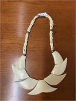 Beaded necklace with carved (bone?) shell design