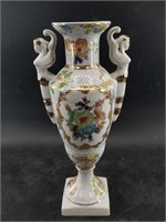 Ornate porcelain vase with raised paint detailing