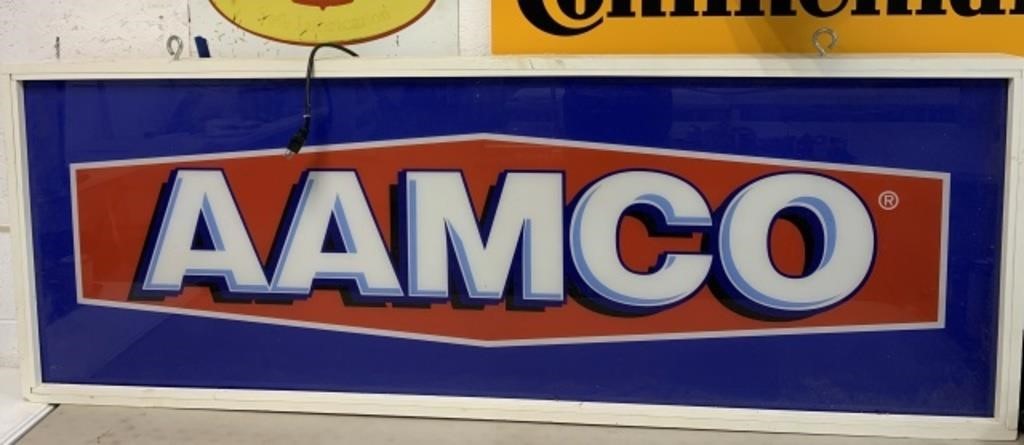 AAMCO plastic signage mounted in wood case