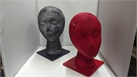 Two human head mannequins with tile base
