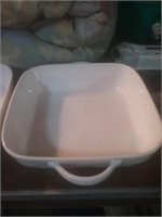 Group of two white casserole dishes with handles