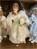 porcelain doll brown hair white and green dress