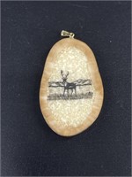 Walrus ivory, intricately scrimmed pendant.