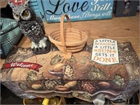 owl statue, fruit tapestry, metal sign,