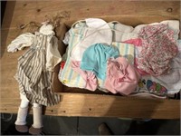 box of doll clothes and doll