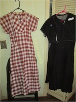 1 brown plaid and 1 black 1950's ladies dress