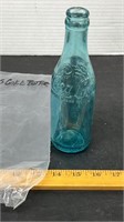 Flat side Blue Coca-Cola Bottle with Emblem on
