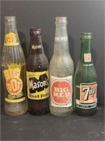 Four vintage soda bottles