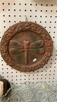 Outdoor wall hanging featuring a dragonfly and