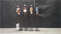 4 TALL FIGURES PLAYING INSTRUMENTS