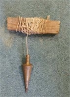 Antique brass plumb bob and string