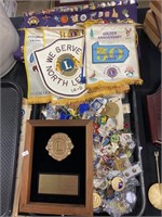 Enamel pins, Lions Club banners, plaque.