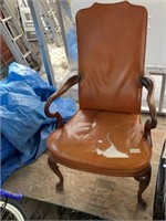 Antique wooden and leather chair. Seat has a subst