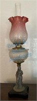 Antique kerosene lamp with Figural base