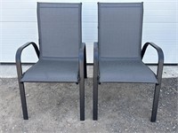 2 black stacking patio chairs